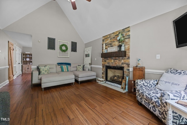 1128 Old Stage Rd S, Erwin, NC 28339 - living room featuring wood finished floors, high vaulted ceiling, a ceiling fan, and a fireplace