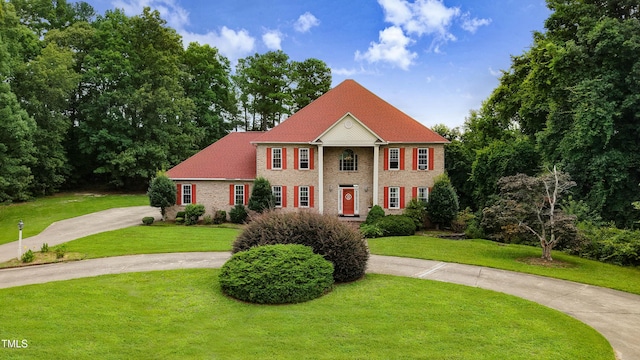 4904 Pebble Beach Cir N, Wilson, NC 27896 - view of front of property with curved driveway, a front lawn, and brick siding