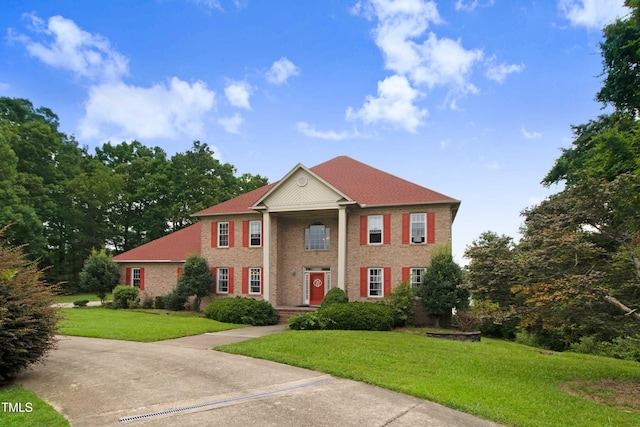 4904 Pebble Beach Cir N, Wilson, NC 27896 - greek revival house featuring a front yard and brick siding