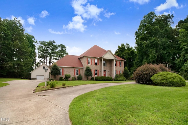 4904 Pebble Beach Cir N, Wilson, NC 27896 - view of front of property with driveway, a front lawn, an outbuilding, and brick siding