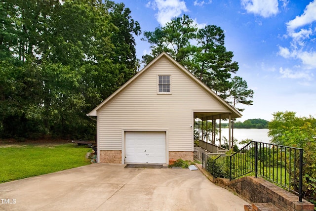 4904 Pebble Beach Cir N, Wilson, NC 27896 - view of side of home featuring a yard, a water view, driveway, and brick siding