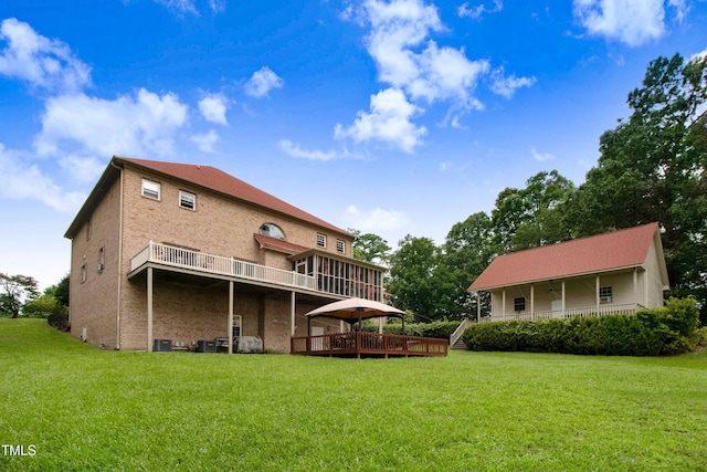 4904 Pebble Beach Cir N, Wilson, NC 27896 - rear view of house featuring a deck and a lawn