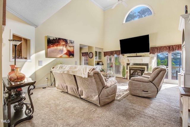 4904 Pebble Beach Cir N, Wilson, NC 27896 - carpeted living area featuring crown molding, a fireplace, healthy amount of natural light, ceiling fan, and a towering ceiling