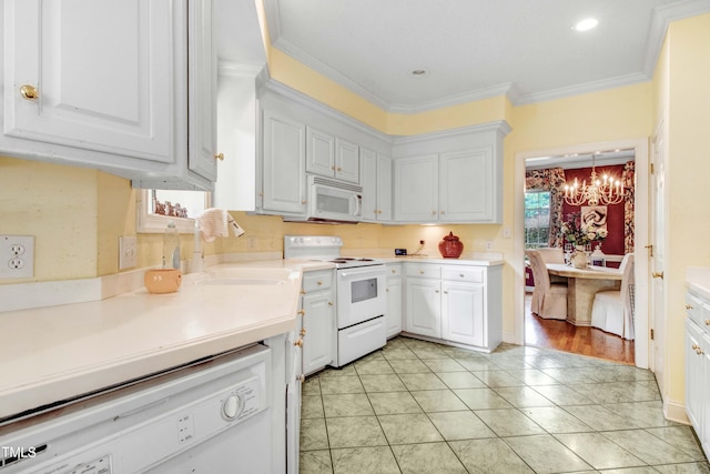 4904 Pebble Beach Cir N, Wilson, NC 27896 - kitchen featuring white appliances, a chandelier, white cabinets, crown molding, and light countertops