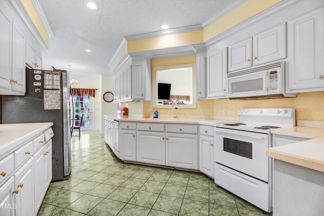 4904 Pebble Beach Cir N, Wilson, NC 27896 - kitchen featuring white appliances, ornamental molding, white cabinets, light countertops, and light tile patterned flooring