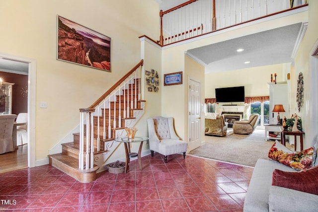 4904 Pebble Beach Cir N, Wilson, NC 27896 - stairs with a high ceiling, ornamental molding, tile patterned flooring, a fireplace, and recessed lighting