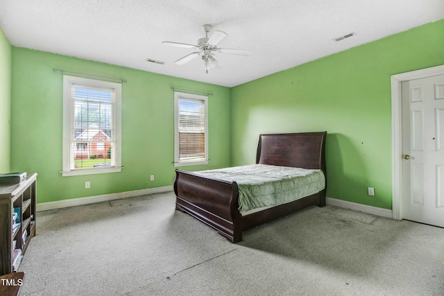 4904 Pebble Beach Cir N, Wilson, NC 27896 - carpeted bedroom featuring multiple windows, a ceiling fan, and a textured ceiling