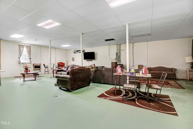 4904 Pebble Beach Cir N, Wilson, NC 27896 - living room featuring finished concrete flooring, concrete block wall, and electric panel