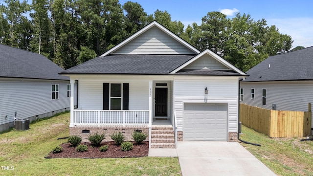 312 E Yukon St, Kenly, NC 27542 - view of front of property with covered porch, concrete driveway, roof with shingles, crawl space, and an attached garage