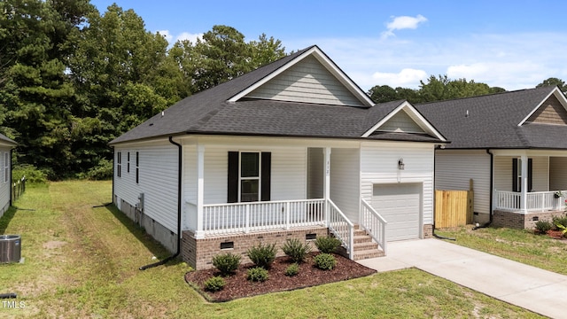 312 E Yukon St, Kenly, NC 27542 - view of front of home with covered porch, an attached garage, and a front yard
