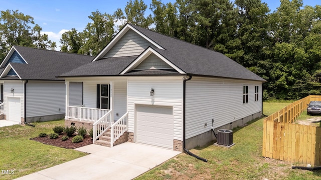 312 E Yukon St, Kenly, NC 27542 - view of front of house featuring a porch, a garage, crawl space, a shingled roof, and driveway