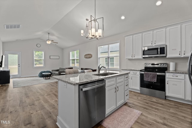 312 E Yukon St, Kenly, NC 27542 - kitchen with appliances with stainless steel finishes, lofted ceiling, light wood finished floors, ceiling fan, and white cabinetry