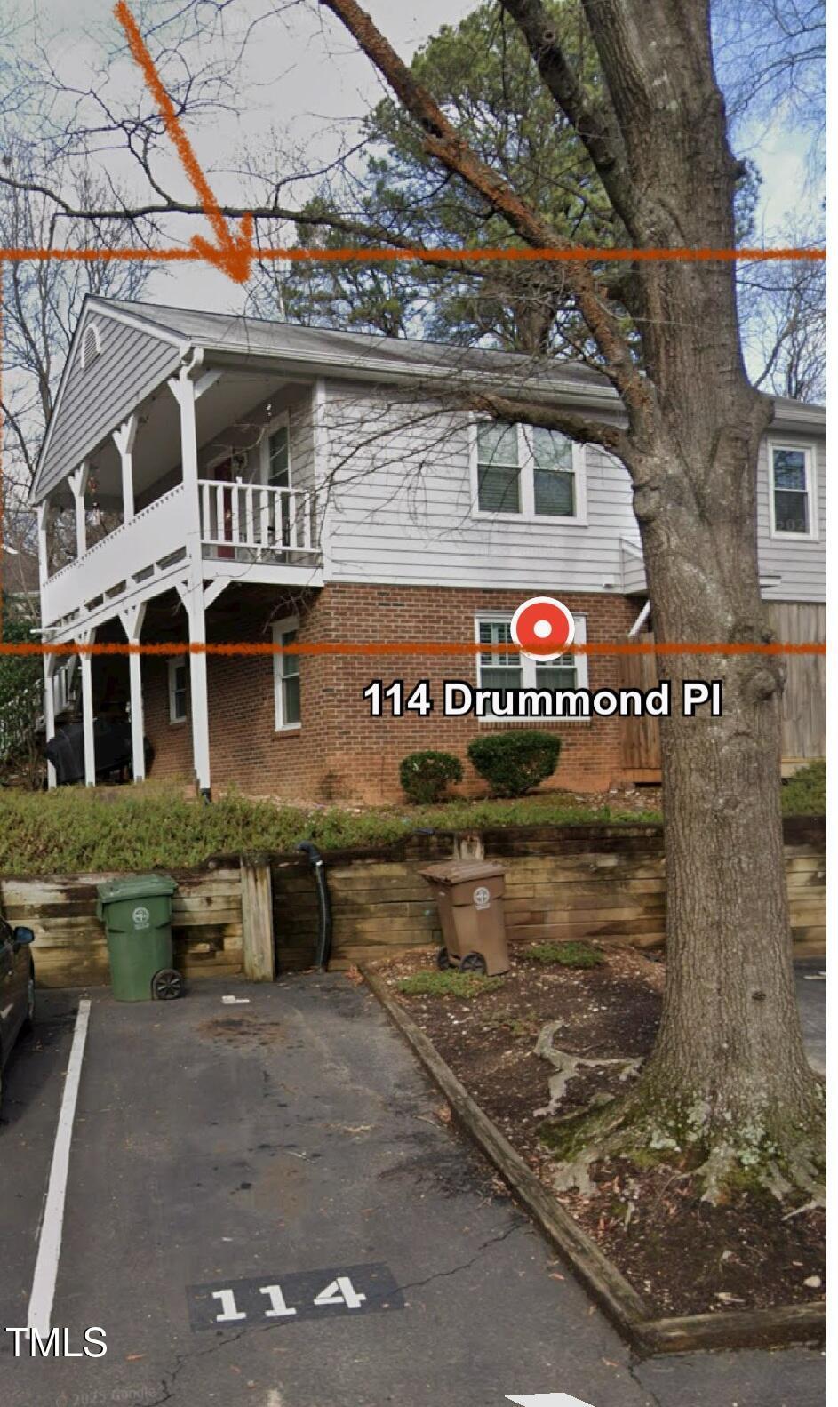 114 Drummond Pl, Cary, NC 27511 - view of home's exterior featuring brick siding, a balcony, and uncovered parking