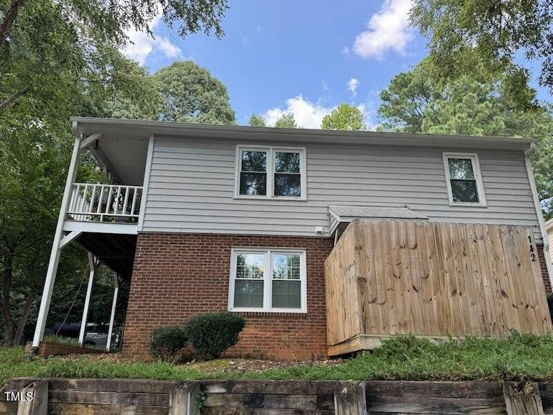 114 Drummond Pl, Cary, NC 27511 - view of home's exterior featuring brick siding and a balcony