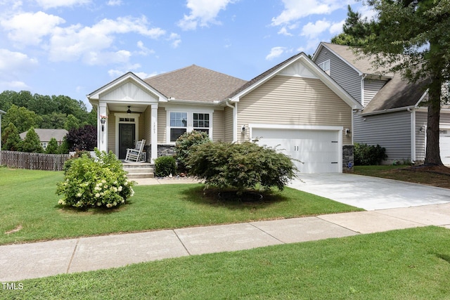 1205 Barnford Mill Rd, Wake Forest, NC 27587 - view of front facade featuring an attached garage, driveway, a porch, a shingled roof, and stone siding