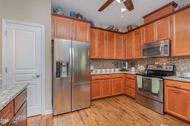 1205 Barnford Mill Rd, Wake Forest, NC 27587 - kitchen featuring stainless steel appliances, light wood finished floors, backsplash, and ceiling fan