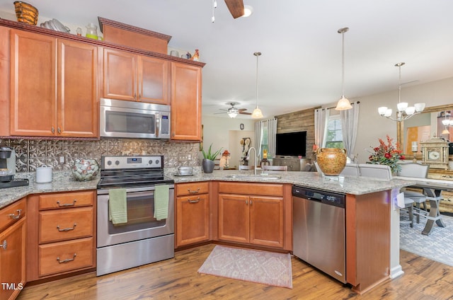 1205 Barnford Mill Rd, Wake Forest, NC 27587 - kitchen featuring stainless steel appliances, a ceiling fan, a peninsula, and open floor plan