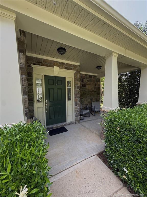 5724 Avera Ln, Holly Springs, NC 27540 - view of exterior entry featuring stone siding and covered porch
