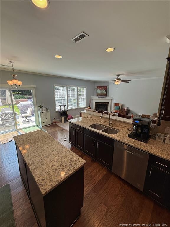 5724 Avera Ln, Holly Springs, NC 27540 - kitchen featuring dishwasher, a ceiling fan, open floor plan, dark wood-style floors, and a fireplace