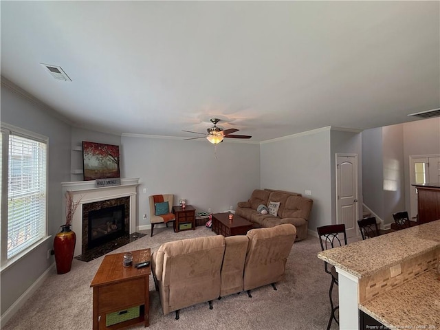 5724 Avera Ln, Holly Springs, NC 27540 - living area featuring a ceiling fan, light carpet, ornamental molding, and a high end fireplace