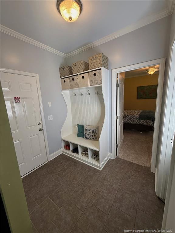 5724 Avera Ln, Holly Springs, NC 27540 - mudroom featuring crown molding and dark tile patterned floors