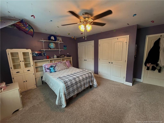 5724 Avera Ln, Holly Springs, NC 27540 - carpeted bedroom with multiple closets and a ceiling fan