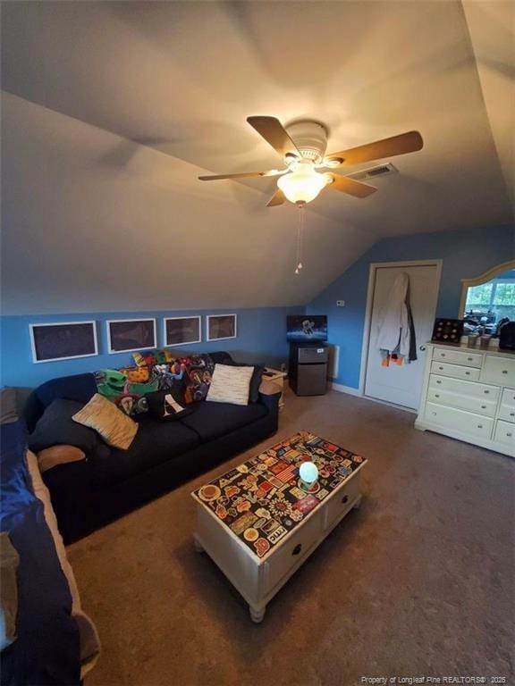 5724 Avera Ln, Holly Springs, NC 27540 - carpeted living room featuring lofted ceiling and ceiling fan