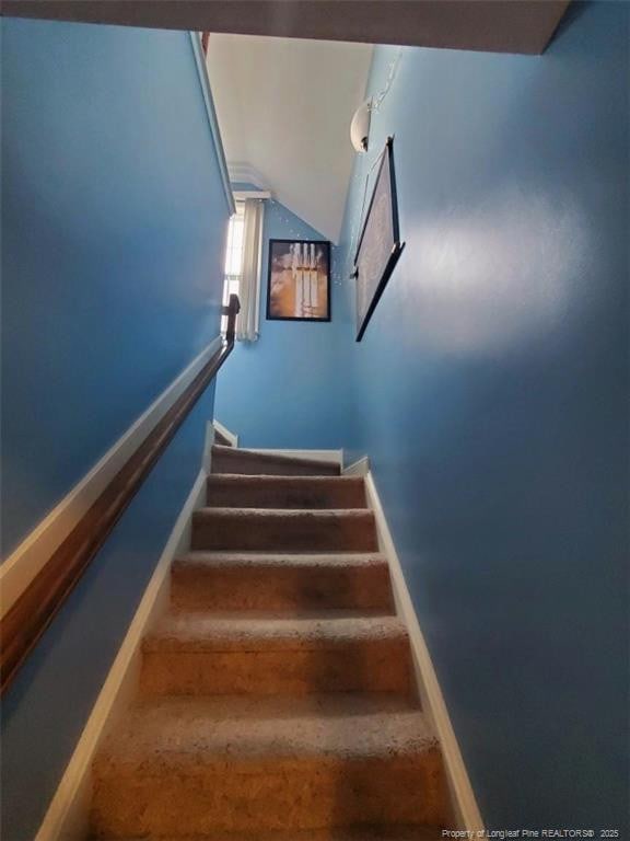 5724 Avera Ln, Holly Springs, NC 27540 - staircase featuring vaulted ceiling and baseboards