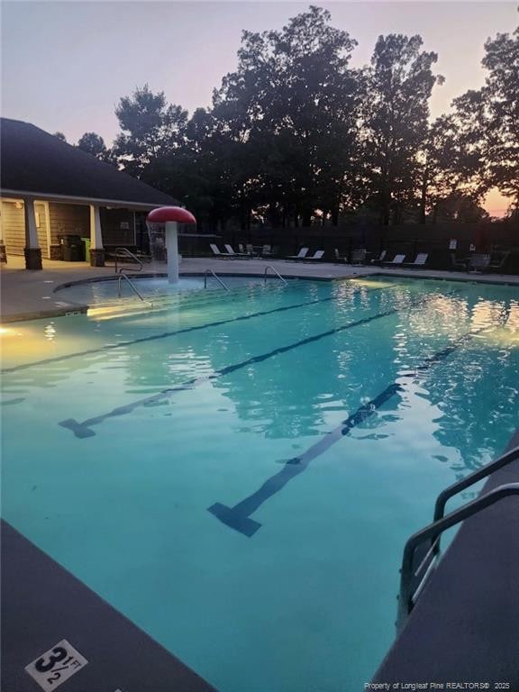5724 Avera Ln, Holly Springs, NC 27540 - pool at dusk with a community pool