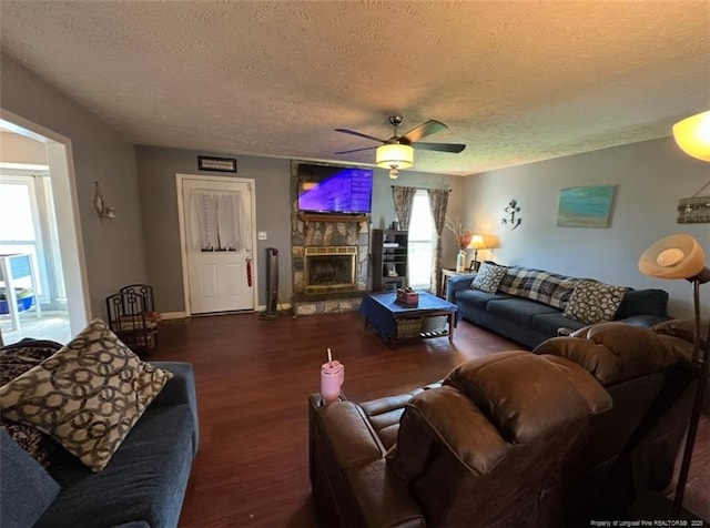 7453 Avila Dr, Fayetteville, NC 28314 - living area with a textured ceiling, wood finished floors, ceiling fan, and a fireplace