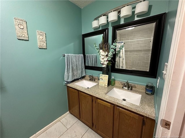 7453 Avila Dr, Fayetteville, NC 28314 - bathroom featuring double vanity and a tile shower