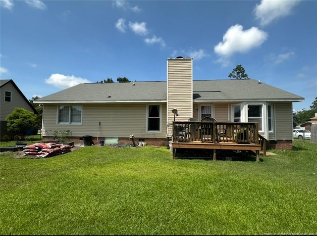 7453 Avila Dr, Fayetteville, NC 28314 - rear view of house featuring a deck, a chimney, and a lawn