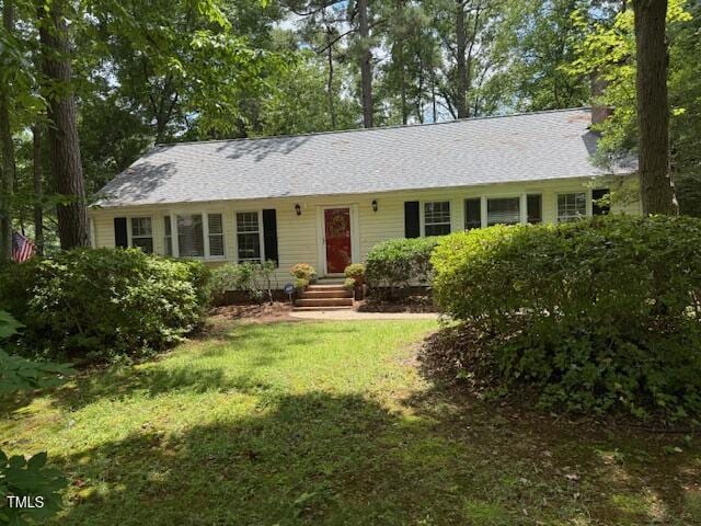 1221 Moultrie Ct, Raleigh, NC 27615 - ranch-style home featuring a front yard and a chimney
