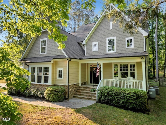 3650 Brooks Bnd, Franklinton, NC 27525 - view of front of property featuring a porch, a shingled roof, stone siding, and a front yard