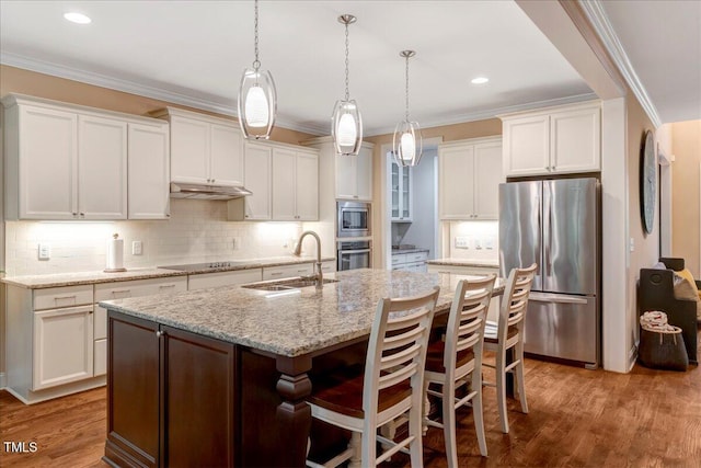 3650 Brooks Bnd, Franklinton, NC 27525 - kitchen with stainless steel appliances, under cabinet range hood, white cabinets, a center island with sink, and tasteful backsplash