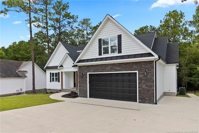232 Captain Hbr, Sanford, NC 27332 - modern farmhouse featuring a standing seam roof, stone siding, concrete driveway, a shingled roof, and a garage
