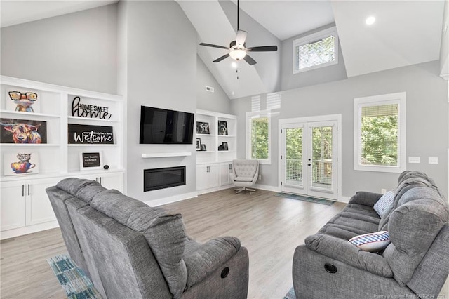 232 Captain Hbr, Sanford, NC 27332 - living area with ceiling fan, high vaulted ceiling, a glass covered fireplace, light wood-type flooring, and french doors