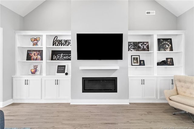 232 Captain Hbr, Sanford, NC 27332 - sitting room featuring vaulted ceiling, light wood-style flooring, and a fireplace