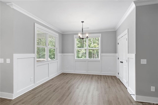 232 Captain Hbr, Sanford, NC 27332 - unfurnished dining area featuring ornamental molding, wood finished floors, a chandelier, a wainscoted wall, and a decorative wall