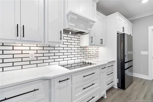 232 Captain Hbr, Sanford, NC 27332 - kitchen featuring freestanding refrigerator, custom exhaust hood, black electric stovetop, ornamental molding, and white cabinets