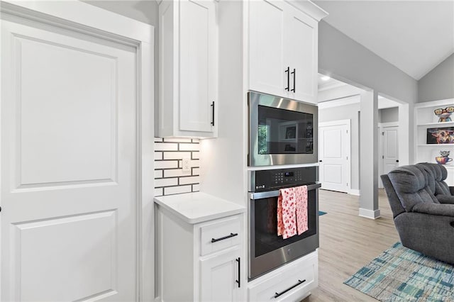 232 Captain Hbr, Sanford, NC 27332 - kitchen with appliances with stainless steel finishes, light countertops, white cabinetry, light wood-style floors, and open floor plan