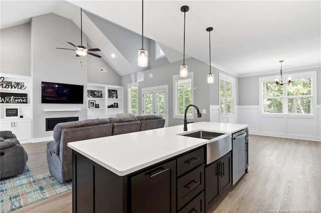 232 Captain Hbr, Sanford, NC 27332 - kitchen featuring stainless steel dishwasher, light wood finished floors, light countertops, a chandelier, and wainscoting