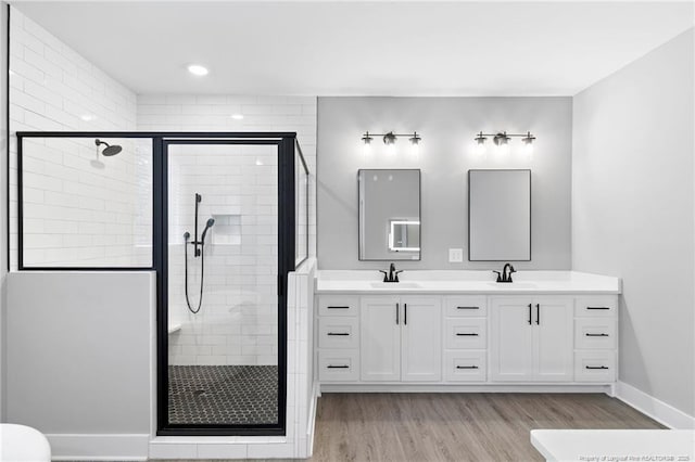 232 Captain Hbr, Sanford, NC 27332 - bathroom featuring double vanity, a stall shower, and wood finished floors