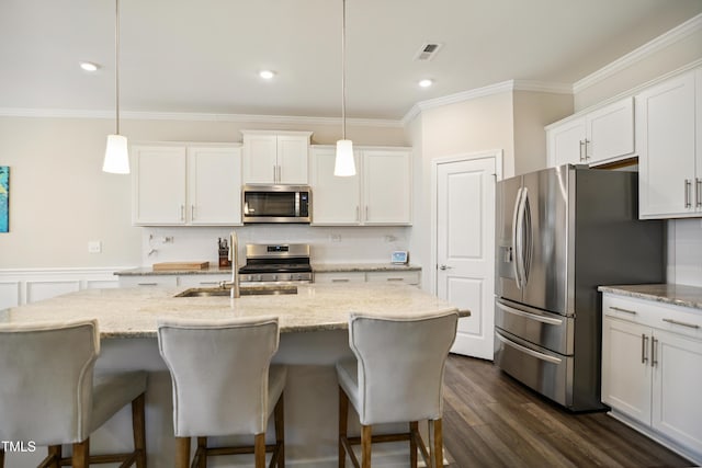 4805 Ozark St, Fuquay Varina, NC 27526 - kitchen featuring appliances with stainless steel finishes, ornamental molding, tasteful backsplash, white cabinets, and pendant lighting