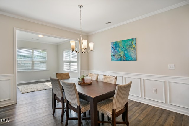 4805 Ozark St, Fuquay Varina, NC 27526 - dining space featuring dark wood-style flooring, a chandelier, ornamental molding, a wainscoted wall, and a decorative wall