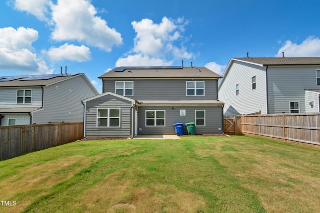 4805 Ozark St, Fuquay Varina, NC 27526 - back of property with solar panels, a fenced backyard, and a patio area