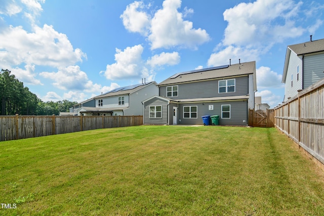 4805 Ozark St, Fuquay Varina, NC 27526 - back of house with a fenced backyard, roof mounted solar panels, and a gate