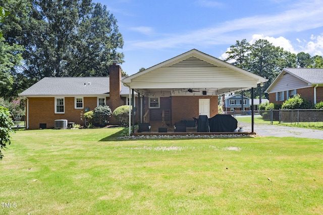5203 Shady Bluff St, Durham, NC 27704 - back of house featuring brick siding, a chimney, a ceiling fan, and driveway