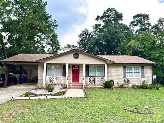 6622 Vaughn Rd, Fayetteville, NC 28304 - ranch-style house featuring brick siding, a carport, a porch, concrete driveway, and a front lawn