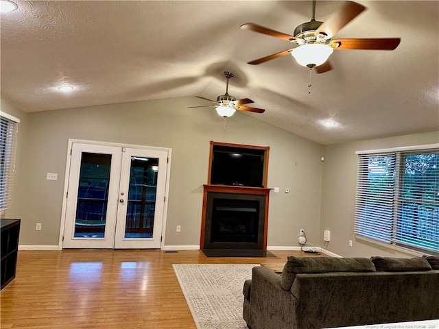 6622 Vaughn Rd, Fayetteville, NC 28304 - living area featuring ceiling fan, vaulted ceiling, french doors, wood finished floors, and a textured ceiling